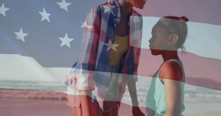 American flag animation over two people standing on beach, enjoying view - Powered by Adobe