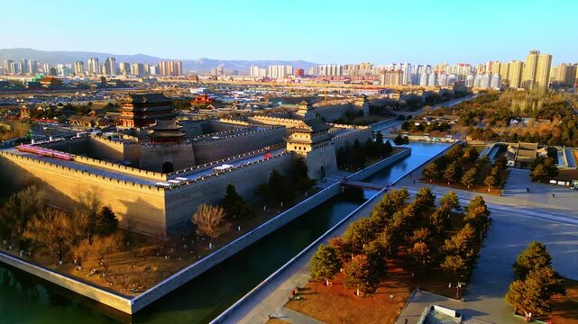 Aerial view of the ancient city walls surrounded by a moat contrasting with the modern skyline in the background, Datong, Shanxi, China.