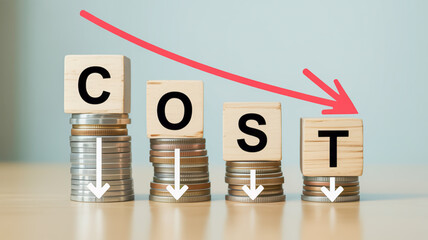Four stacks of coins with wooden blocks spelling COST and a red arrow indicating a downward trend