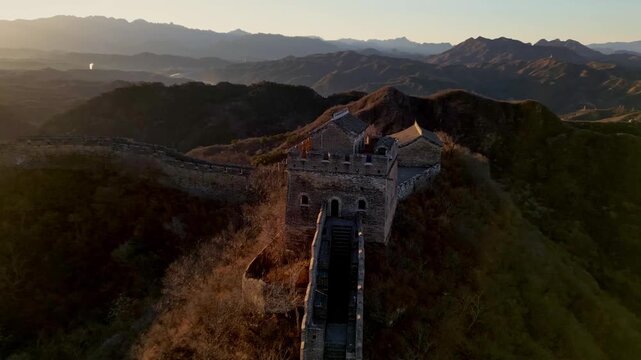 Aerial view of the Great Wall of China winding through the rugged mountain landscape, a testament to history and human endeavor, Huairou District, China.