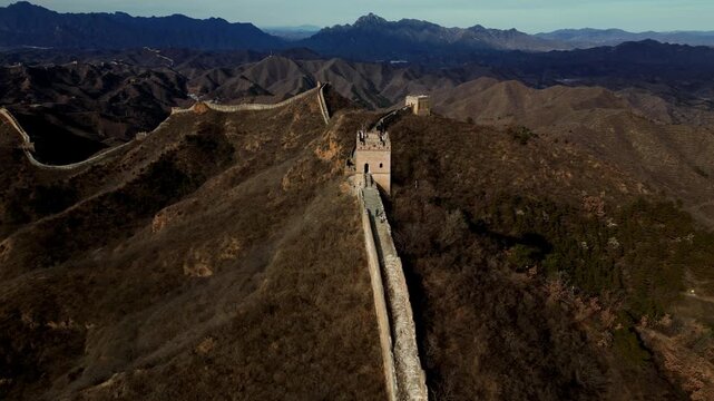 Aerial view of The Great Wall snaking across the rugged mountain terrain, a testament to ancient engineering, Huairou District, Beijing, China.