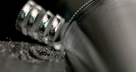 MACRO: Long spirals of excess metal are created as lathe tool creates a screw.