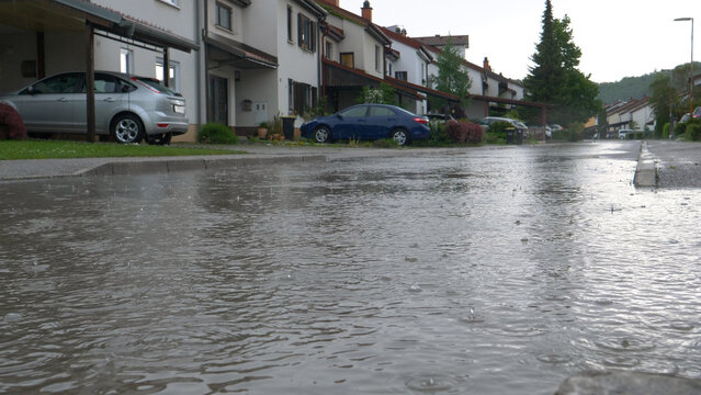 LOW ANGLE: Heavy April rainfall floods the tranquil suburban neighborhood.