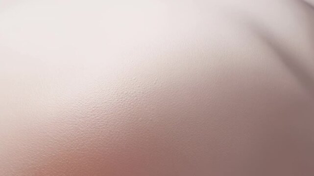 Showing pale textured skin-like surface in close-up, camera shifting light, shadow forming right