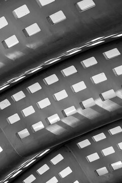 Modern urban architecture abstract curve pattern in metal with reflection and monochrome background for futuristic design copyspace