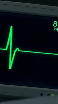 Vertical video: Showing green ECG on ward monitor shifting after QRS spike to flat signaling arrest