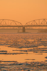 Obraz premium View of the road and railway bridges of the city of Torun at sunset