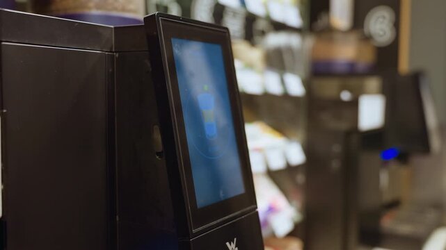 supermarket selfcheckout screen interaction customer hand tapping display, blurred shelves and product labels in background, contactless payment option highlighted, modern terminal with illuminated
