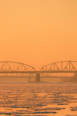 Obraz premium View of the road and railway bridges of the city of Torun at sunset