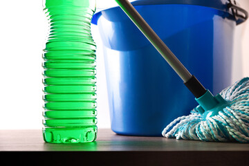 Disinfectant on wooden surface with mop and bucket