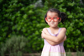 portrait of a little girl in green park