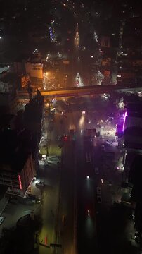 Aerial Night Timelapse of Busy Indian City Street with Flyover and Urban Traffic Flow.