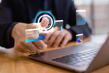 Business professional using fingerprint biometric authentication with data analytics dashboard on laptop, representing cybersecurity, digital identity verification, data protection and secure technolo