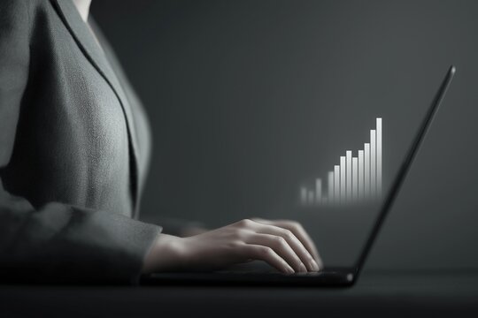 Professional woman typing on laptop with digital bar graph showing business growth. Represents data analysis, finance, career progression, technology, and modern business environment - Powered by Adobe