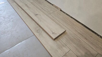 Wooden flooring renovation process showing planks laid on surface