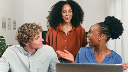 Diverse Team Members Engage in Friendly Startup Brainstorming Session at Modern Office