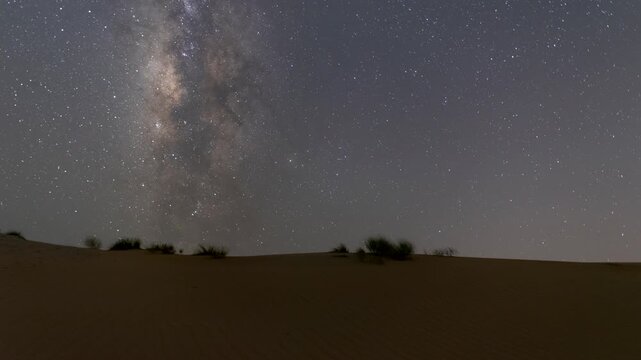 4k timelapse of the night sky transition of moonset and Milky Way galaxy motion in the desert sand dune. lonely desert area  