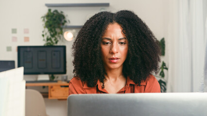 Focused Woman Working on Laptop in Modern Office Studio - Startup Team Vibe for Diverse Workplace Environment
