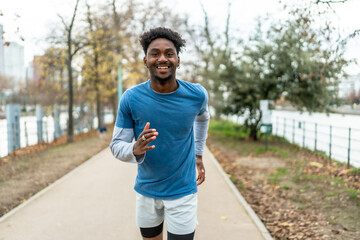 Fototapeta premium Young black man running sport training in paris city