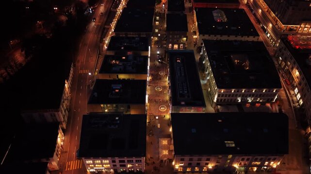 Aerial view of the illuminated Rue du Pont, a street in the Flon neighbourhood, showcasing the vibrant urban landscape at night, Lausanne, Vaud, Switzerland.