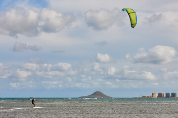 Mature man practicing kitesurfing. Aquatic sport. Athletic healthy senior