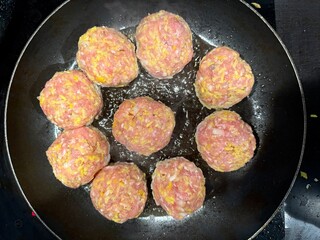 meatballs are cooked in a pan