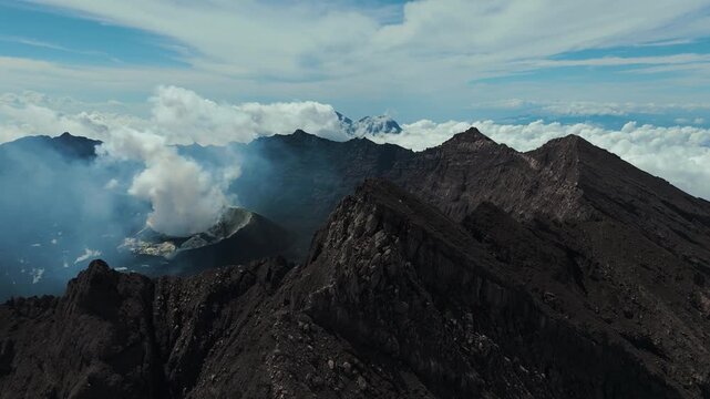 4K drone footage of Mount Raung at sunrise, revealing steep ridges, misty forests, and one of Indonesia&rsquo;s most extreme hiking trails with cloud and vulcano 