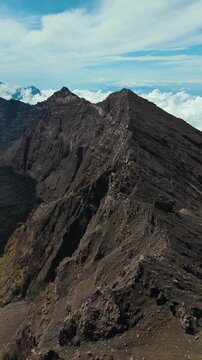 4K drone footage of Mount Raung at sunrise, revealing steep ridges, misty forests, and one of Indonesia&rsquo;s most extreme hiking trails with cloud and vulcano 