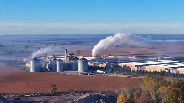 Industrial poultry farm operations creating steam on a misty morning in rural Lake Odessa, Michigan, USA