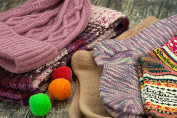 knitted,
clothing,
hat,
socks,
scarf,
fall,
winter,
warm,
lilac,
pink,
Warm knitted clothing items such as socks, a hat, and a scarf. Fall and winter clothing, close-up, on a wooden background.