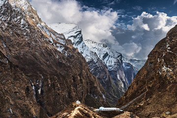 Snow capped steep cliffs in the Annapurna Sanctuary, Himalayan mountains in Nepal