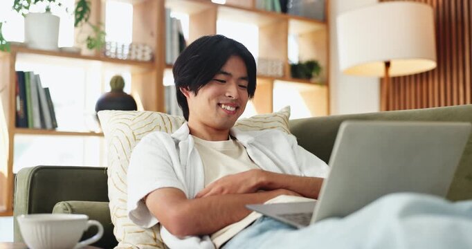 Relax, man and laughing with laptop on couch, funny movie or watch comedy series for entertainment. Streaming comic film, comfortable or asian person with smile in home, subscription site or computer