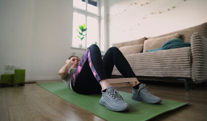 Girl Doing Fitness Exercises With Rubber Resistance Band, Doing Abs Exercises On A Floor