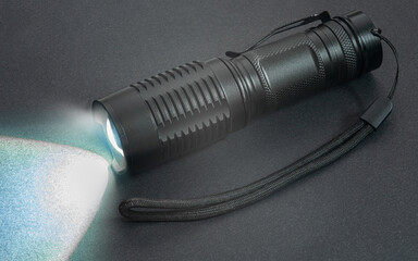 hand flashlight close-up, on a black background