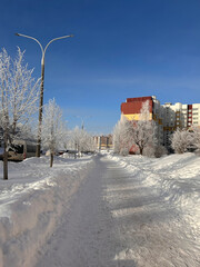 A city covered in snow. Heavy snowfall, frost and blizzard in the city.