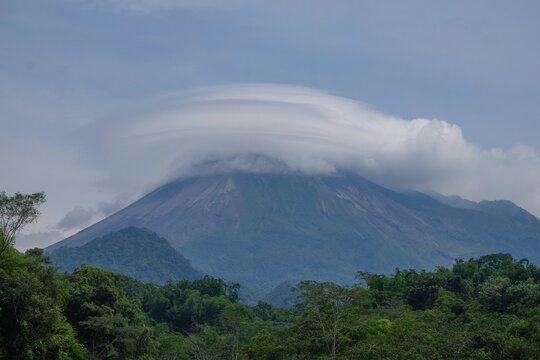 View of a volcano covered in lenticular clouds. Mount Merapi in Yogyakarta, Indonesia. For graphic design, 3D rendering and banners