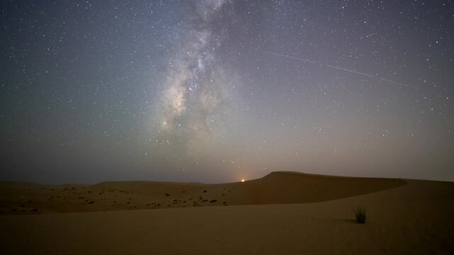 Stunning 4k timelapse of the night sky transition of moonset and Milky Way galaxy motion in the desert sand dune.  stars scape in a remote wilderness location