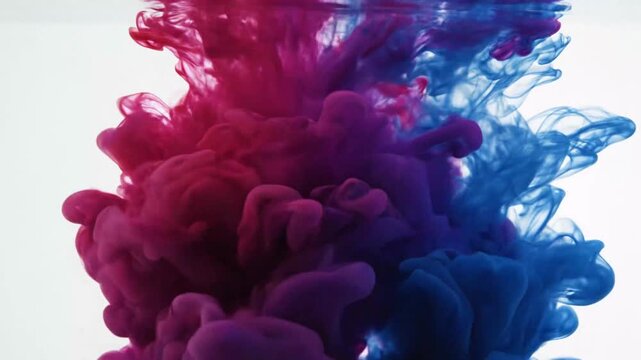 Abstract ink cloud formation in water against a white background