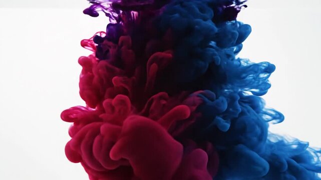 Abstract ink flow in water creating colorful forms on white background