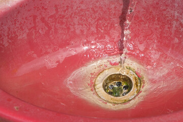 Close up of tap water entering the sink hole. For graphic design, 3D rendering and banners