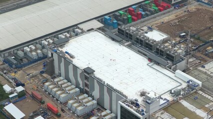 Workers walking on data center roof at digital infrastructure construction site - Powered by Adobe
