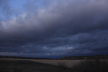 A Prairie storm clouds and setting sun. 