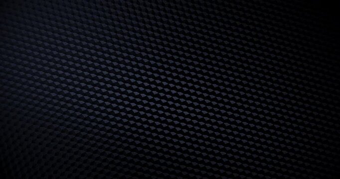 Close-up of premium black carbon fiber weave with subtle light shift, creating a high-tech, endlessly background. Seamless loop.
