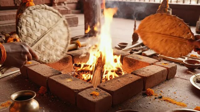 Devotees perform sacred yajna fire ritual inside a temple commemorating maharishi dayanand saraswati jayanti ceremony.