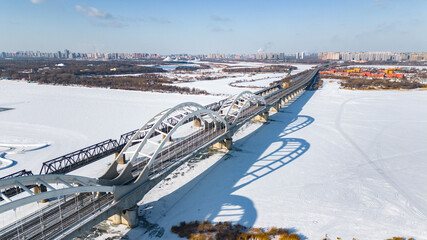 Aerial photography of Zhongdong Bridge and railway bridge across the frozen Songhua river in winter season in Heilongjiang province.