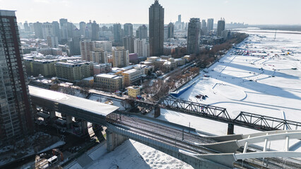 Aerial photography of Zhongdong Bridge and railway bridge across the frozen Songhua river in winter season in Heilongjiang province.