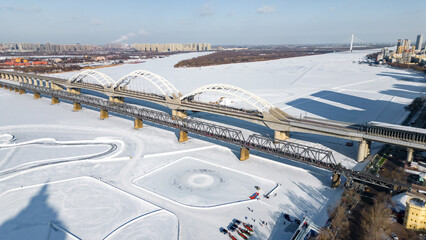 Aerial photography of Zhongdong Bridge and railway bridge across the frozen Songhua river in winter season in Heilongjiang province.