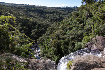 Obraz premium Waterfall View from Above Overlooking Dense Green Valley
