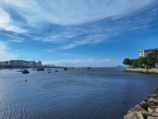 Serene Bay View with Boats Under a Bright Blue Sky