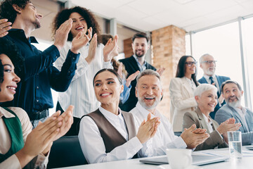 Diverse business team applauding during an indoor office meeting showcasing successful collaboration and teamwork